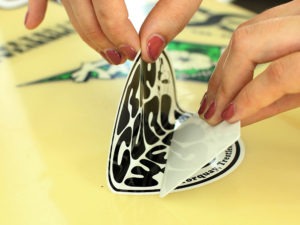 how to put stickers on a surfboard